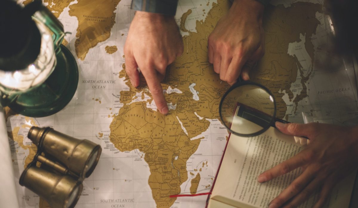 crop-hands-with-magnifying-glass-map